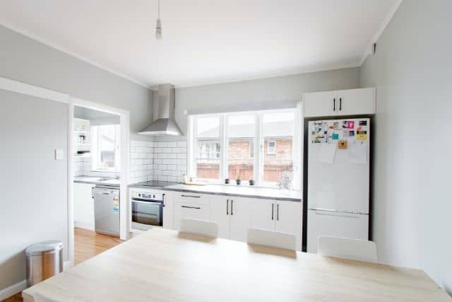 A kitchen with a refrigerator