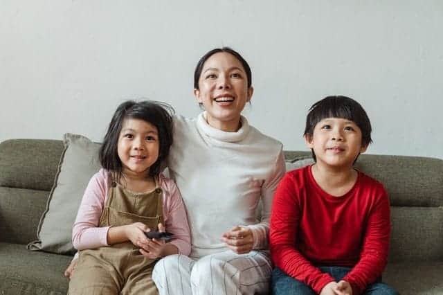 Family watching movie with projector