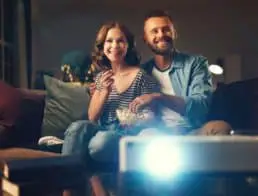Couple watching a movie using a projector